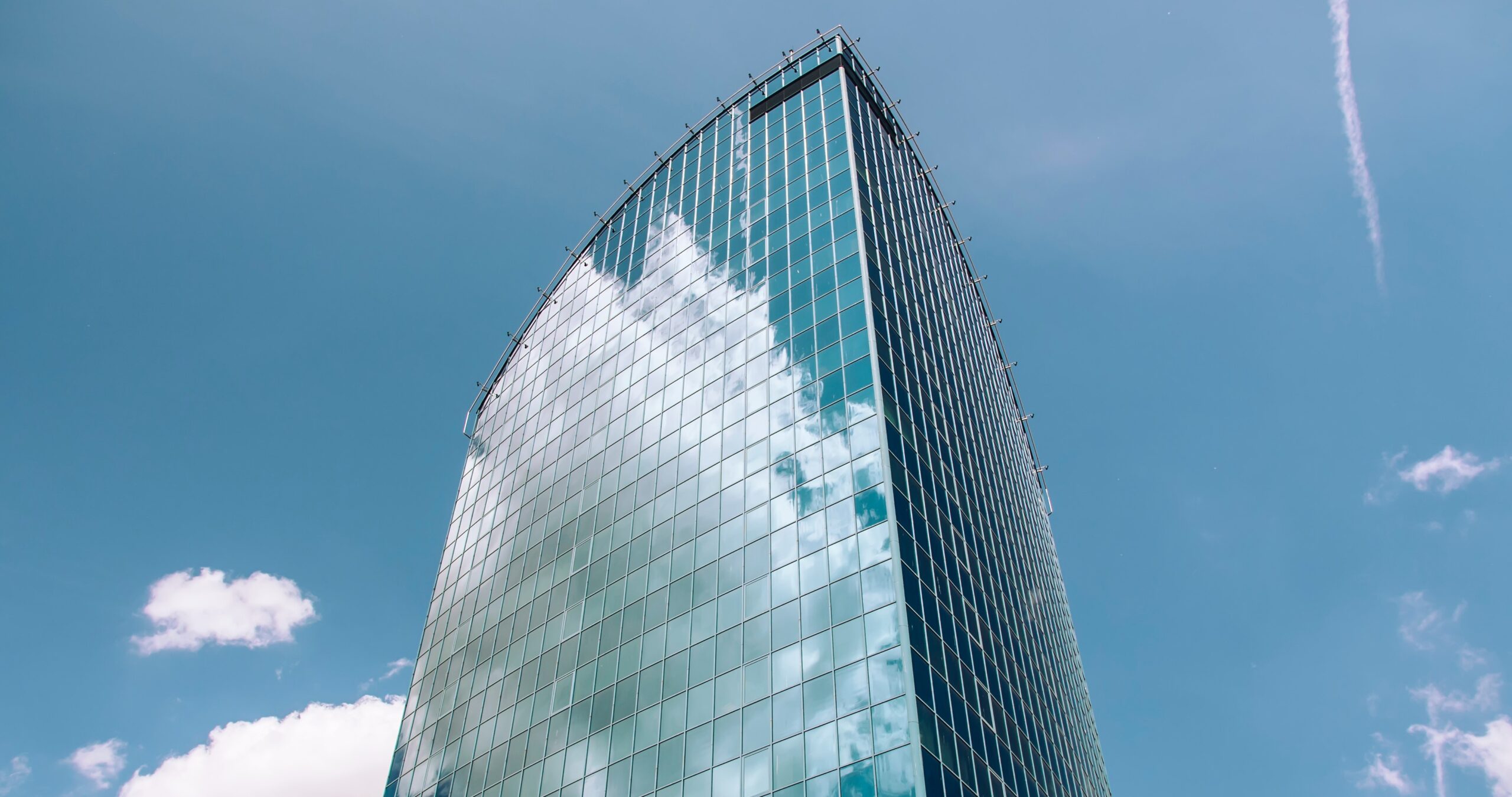 HiRISE Building in Fort Worth, TX on a sunny day, with commercial cleaning activities visible at ground level, showcasing a clean and well-maintained urban environment.