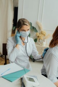 Photo of a doctor in Fort Worth providing one-on-one care in a professionally cleaned and sanitized medical office.