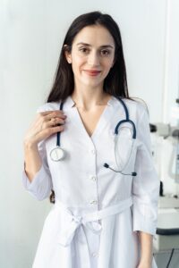 Smiling doctor in a clean, well-organized office maintained by our professional cleaning services.