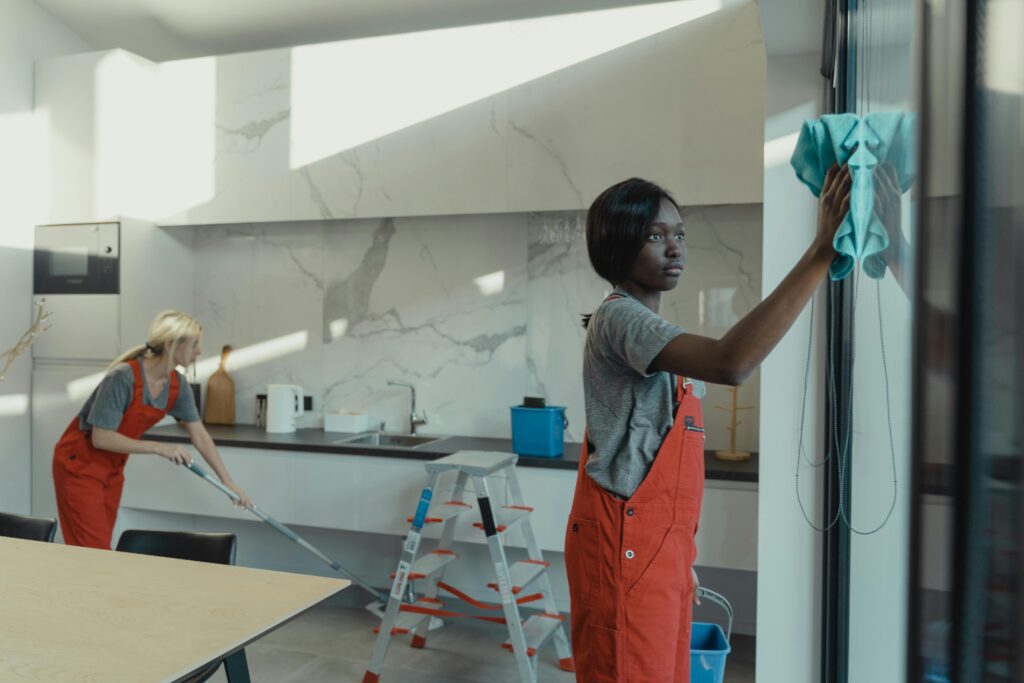 Professional cleaners using advanced techniques and equipment to thoroughly clean and sanitize an office space, ensuring a spotless and hygienic work environment.